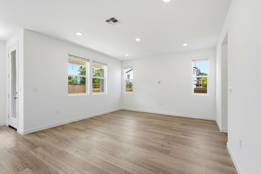 A room with a wood floor and windows. A room with a wood floor and windows.