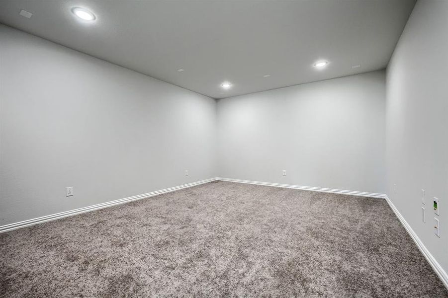 Carpeted empty room featuring recessed lighting and baseboards Carpeted empty room featuring recessed lighting and baseboards
