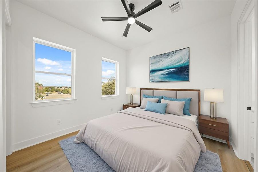 Virtually Staged: Secondary Bedroom with luxury vinyl plank floors, large windows, a ceiling fan, and a functional walk-in closet along with an en-suite bathroom. Photos are from a similar unit in the development.