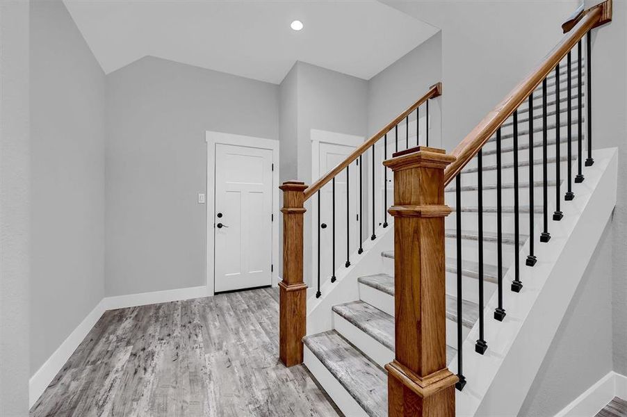 Stairway featuring hardwood / wood-style flooring