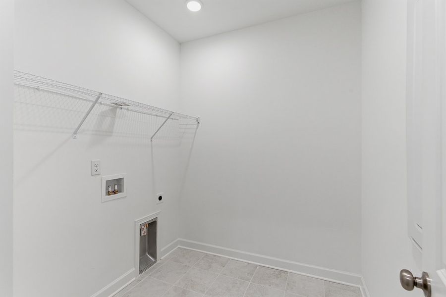 A white hallway with a light on the ceiling. A white hallway with a light on the ceiling.