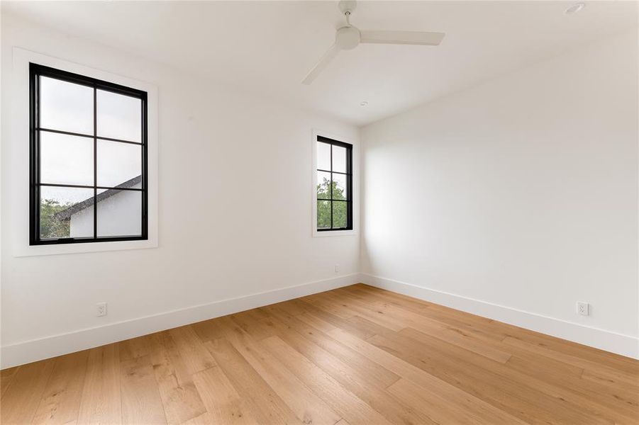 Unfurnished room with light wood finished floors and ceiling fan