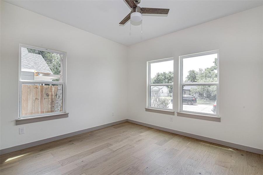 Bedroom with light wood-type flooring and a ceiling fan