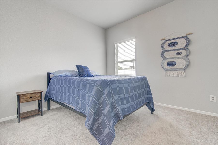 Comfortable bedroom offers soft carpeting and natural light through the window. Comfortable bedroom offers soft carpeting and natural light through the window.