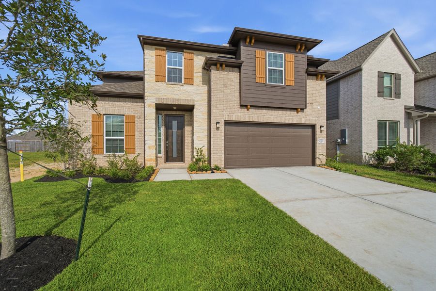 Front exterior of a new home in Lago Mar, Texas City, TX, highlighting curb appeal (Image 25). Front exterior of a new home in Lago Mar, Texas City, TX, highlighting curb appeal (Image 25).