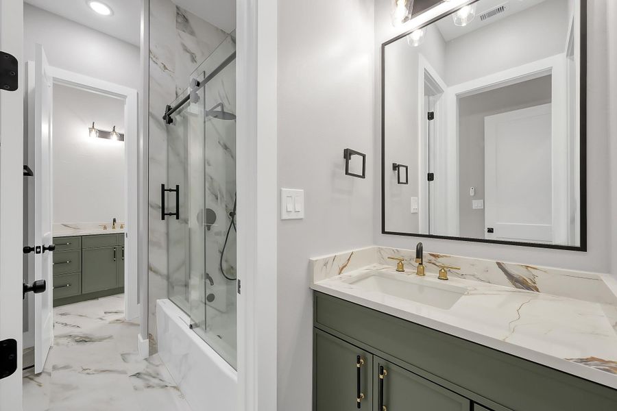 Two secondary bedrooms share a convenient Hollywood-style bathroom setup