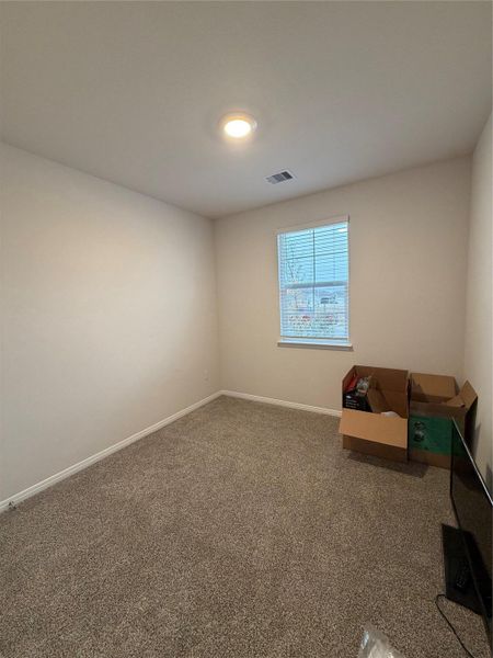 Empty room with carpet floors and baseboards