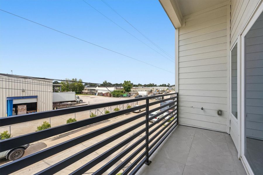 Private balcony with modern horizontal railing, offering elevated views and a low-maintenance outdoor space perfect for relaxing.