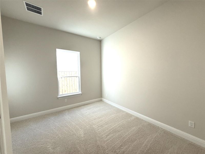 Unfurnished room featuring baseboards and light colored carpet