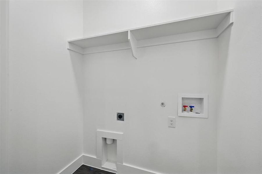 Washroom with dark wood-type flooring, baseboards, electric dryer hookup, laundry area, and washer hookup Washroom with dark wood-type flooring, baseboards, electric dryer hookup, laundry area, and washer hookup