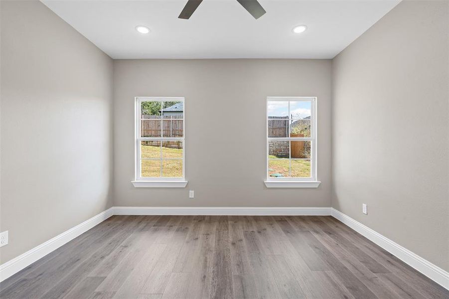 Unfurnished room featuring plenty of natural light, light wood finished floors, and recessed lighting Unfurnished room featuring plenty of natural light, light wood finished floors, and recessed lighting