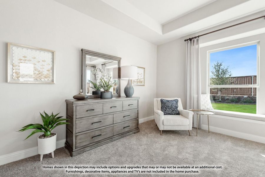 Bedroom with gray dresser, mirror, white accent chair, and large window with backyard view Bedroom with gray dresser, mirror, white accent chair, and large window with backyard view