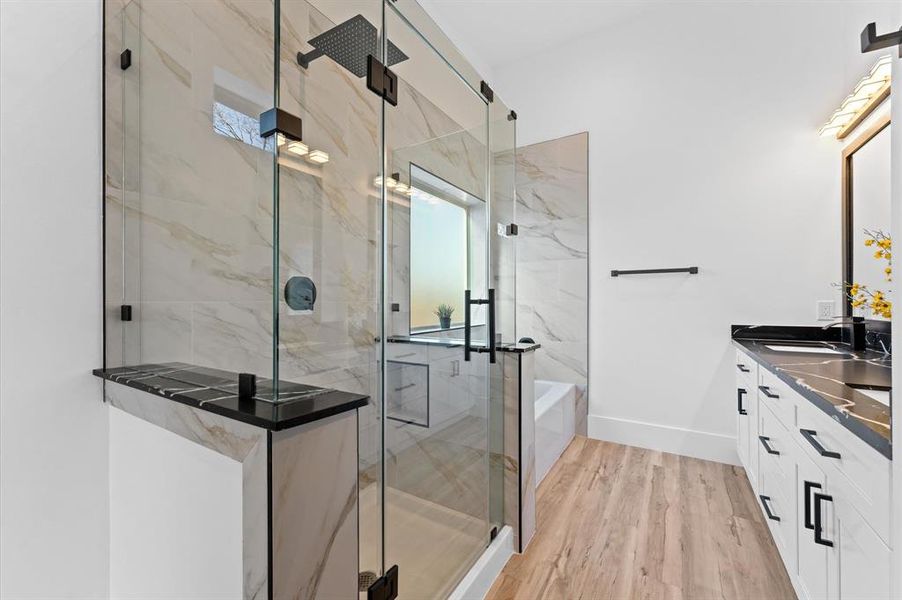 Primary bathroom with sleek modern finishes, a spacious layout, and high-end details create a spa-like retreat.