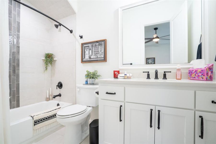 Full bath featuring vanity, bathtub / shower combination, and light tile patterned flooring Full bath featuring vanity, bathtub / shower combination, and light tile patterned flooring