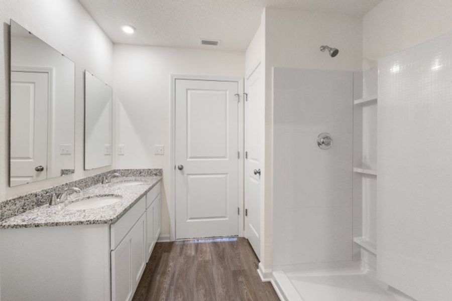 A bathroom with white cabinets. A bathroom with white cabinets.