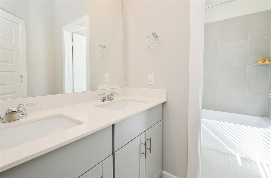 This guest bath offers double sinks.