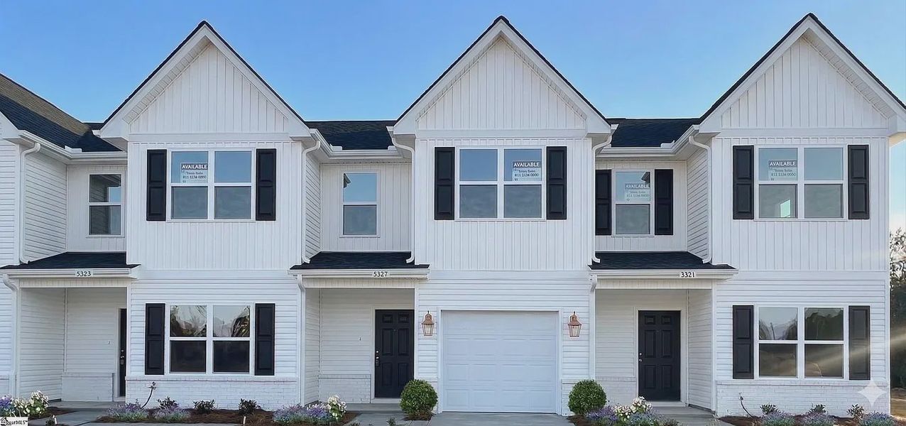 Front exterior of a new home in Parkstone Place Townhomes, Roebuck, SC, highlighting curb appeal (Image 1). Front exterior of a new home in Parkstone Place Townhomes, Roebuck, SC, highlighting curb appeal (Image 1).