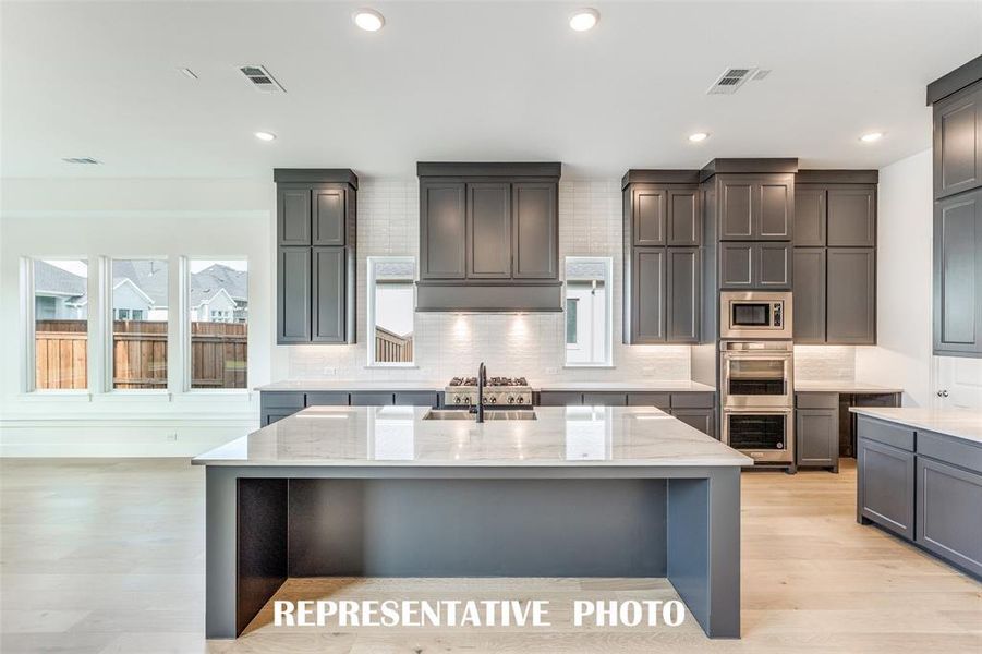 Gorgeous finishes combined with tons of storage make this a kitchen the entire family will love.  REPRESENTATIVE PHOTO