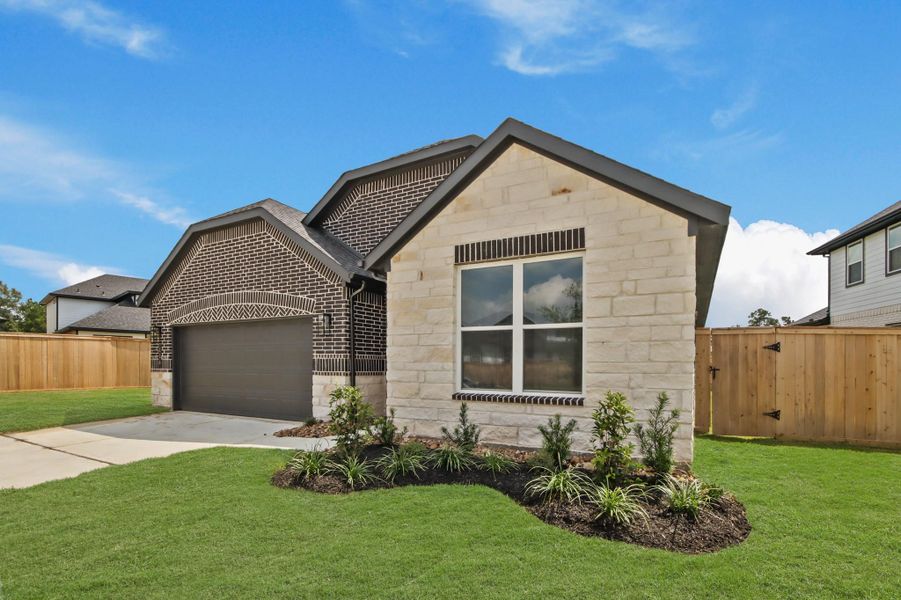 Front exterior of a new home in Hills of Westlake, Conroe, TX, highlighting curb appeal (Image 2).