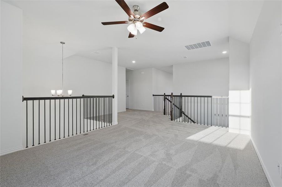 Unfurnished room with carpet flooring, a chandelier, ceiling fan, vaulted ceiling, and recessed lighting Unfurnished room with carpet flooring, a chandelier, ceiling fan, vaulted ceiling, and recessed lighting