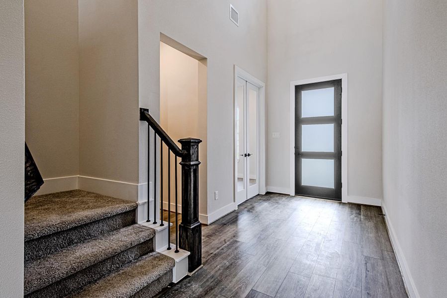 Entryway featuring staircase access and an open-concept layout Entryway featuring staircase access and an open-concept layout
