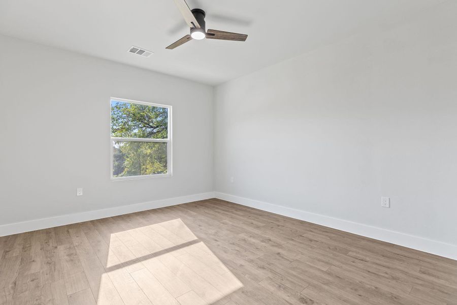 Unfurnished room with light wood finished floors and ceiling fan