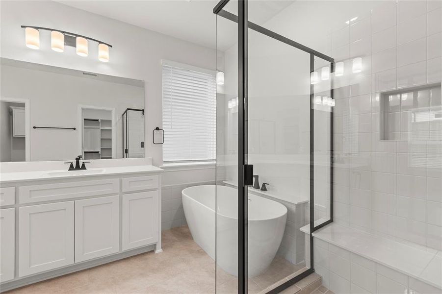 Bathroom with plus walk in shower, vanity, and tile patterned flooring