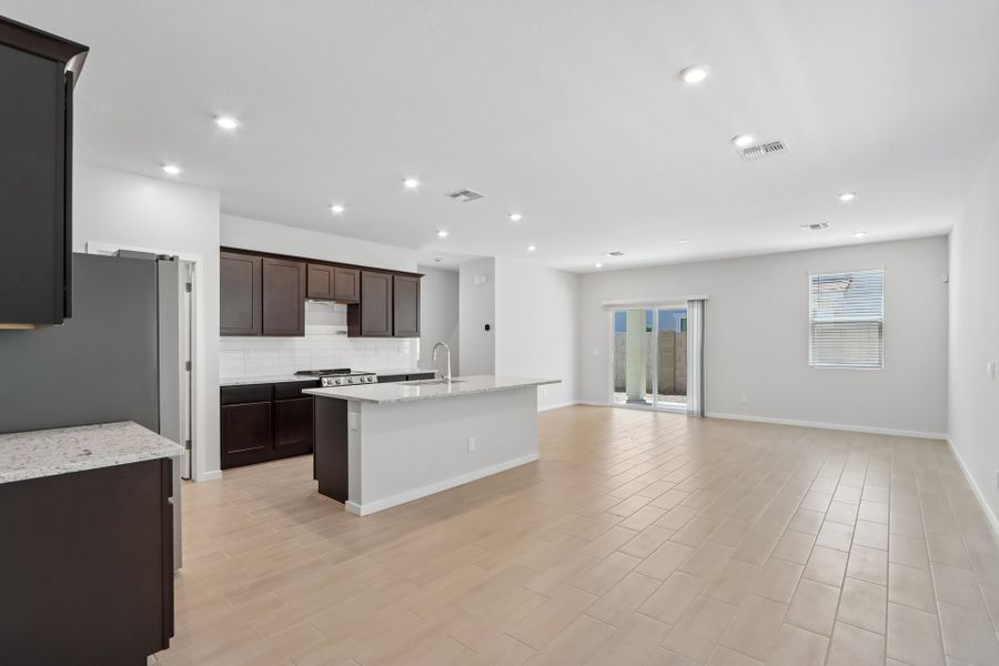 A large kitchen with a wood floor.