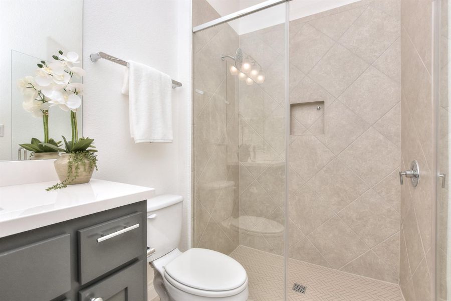 Bathroom featuring vanity and a shower stall