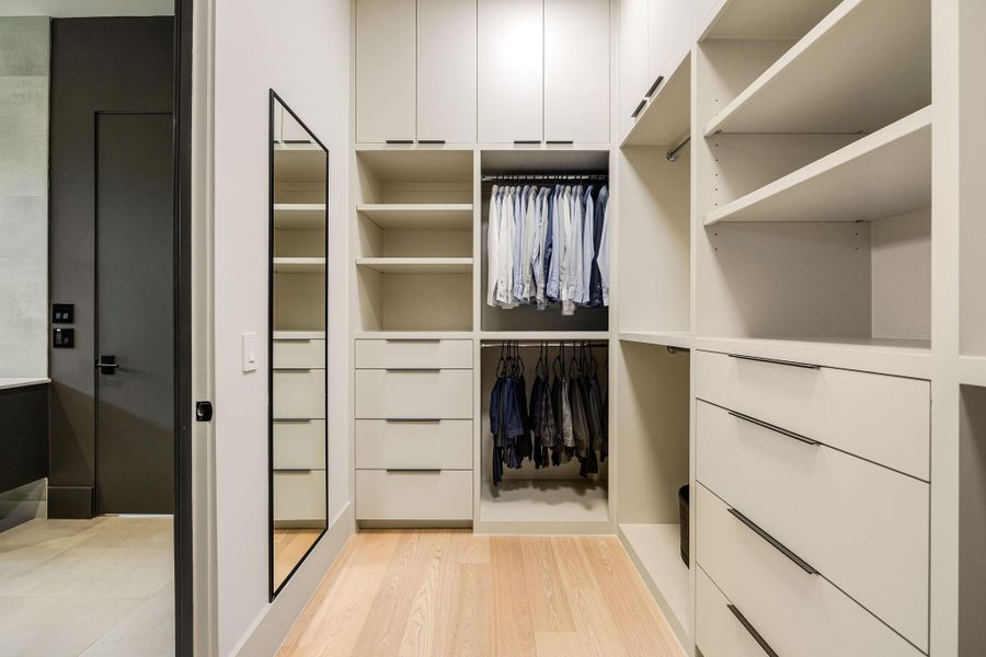 [PRIMARY CLOSET #1] The expansive custom walk-in closet is beautifully appointed with extensive built-in storage, generous hanging space, and thoughtfully designed organization for effortless everyday living.