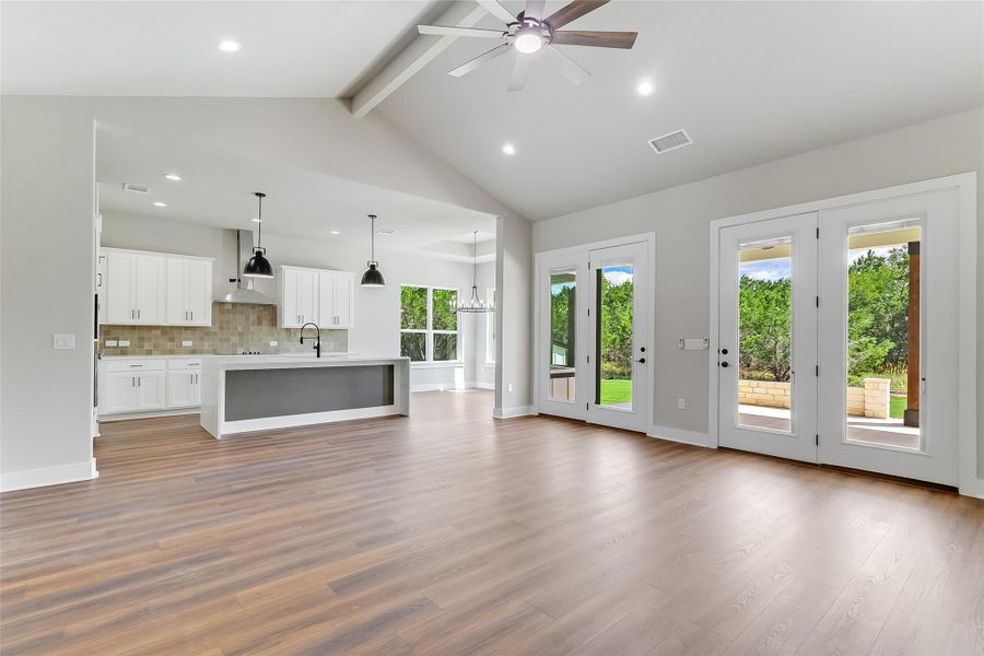 Unfurnished living room featuring ceiling fan, beam ceiling, recessed lighting, and light wood-type flooring