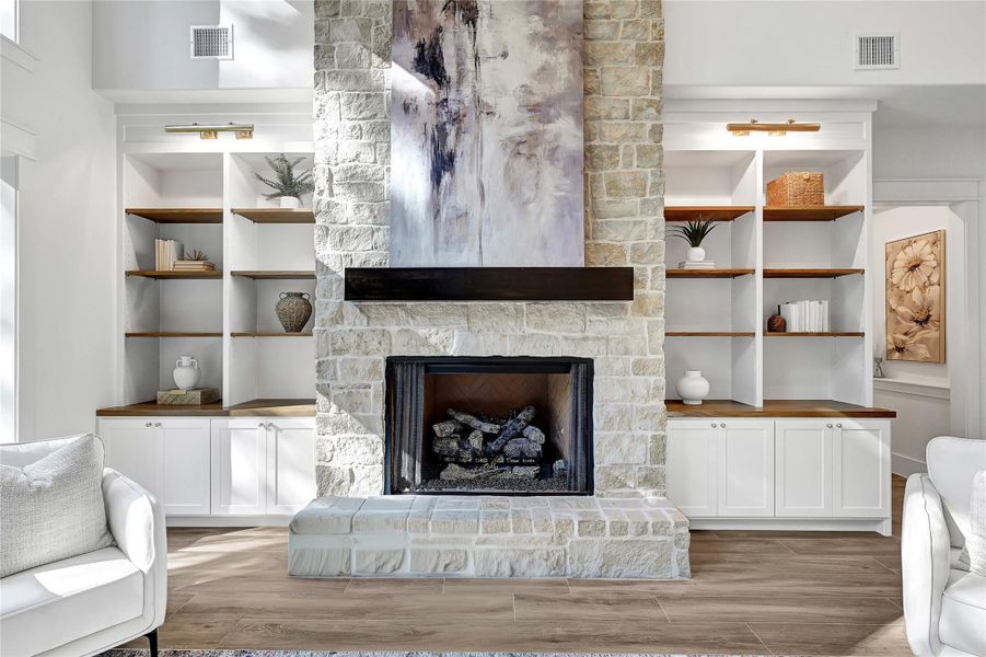 Beautiful floor-to-ceiling gas fireplace with built-ins.