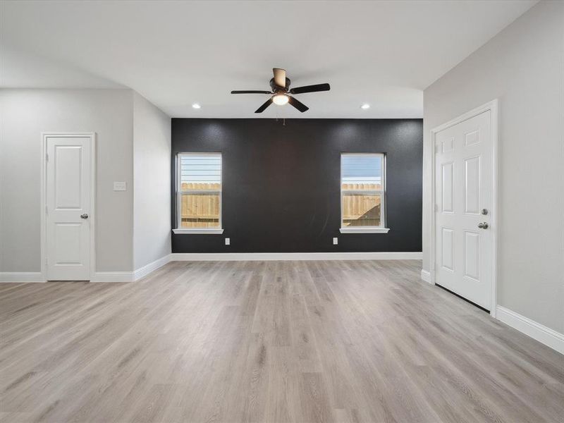 Spare room featuring ceiling fan and light wood-type flooring