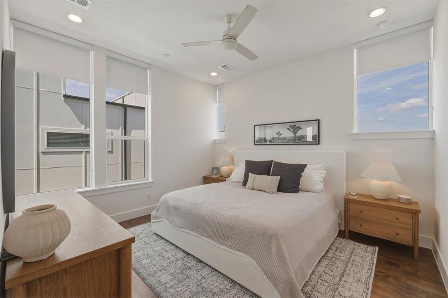 Bedroom featuring a ceiling fan, wood finished floors, and recessed lighting