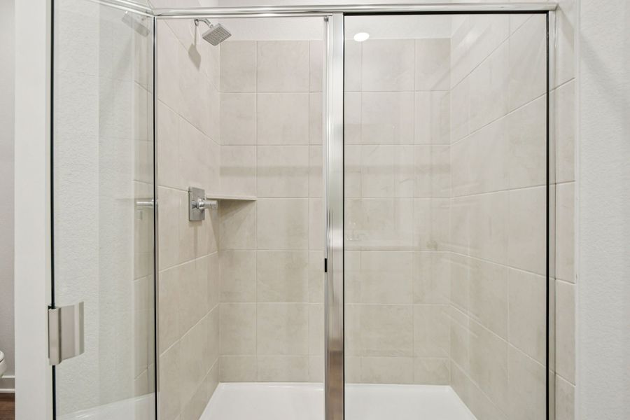 A shower with a glass door.
