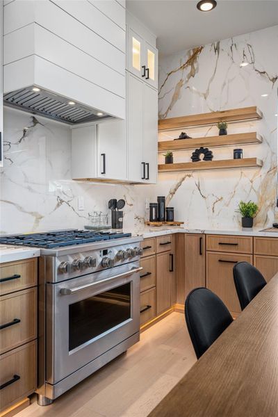 Premium six-burner GE Café range anchors the kitchen with high-performance style