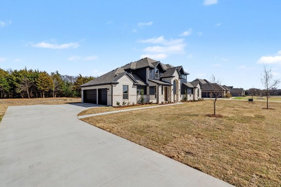 Front exterior of a new home in Sagebrush Addition, Midlothian, TX, highlighting curb appeal (Image 19). Front exterior of a new home in Sagebrush Addition, Midlothian, TX, highlighting curb appeal (Image 19).
