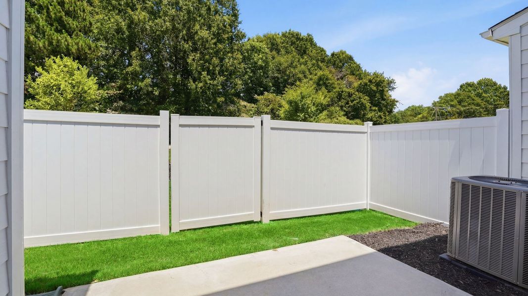 Backyard creates a seamless extension of this townhome’s elegant design at Gresham Station in Simpsonville, SC