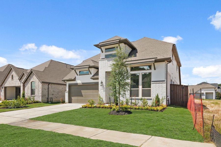Front exterior of a new home in The Trails, New Caney, TX, highlighting curb appeal (Image 29). Front exterior of a new home in The Trails, New Caney, TX, highlighting curb appeal (Image 29).
