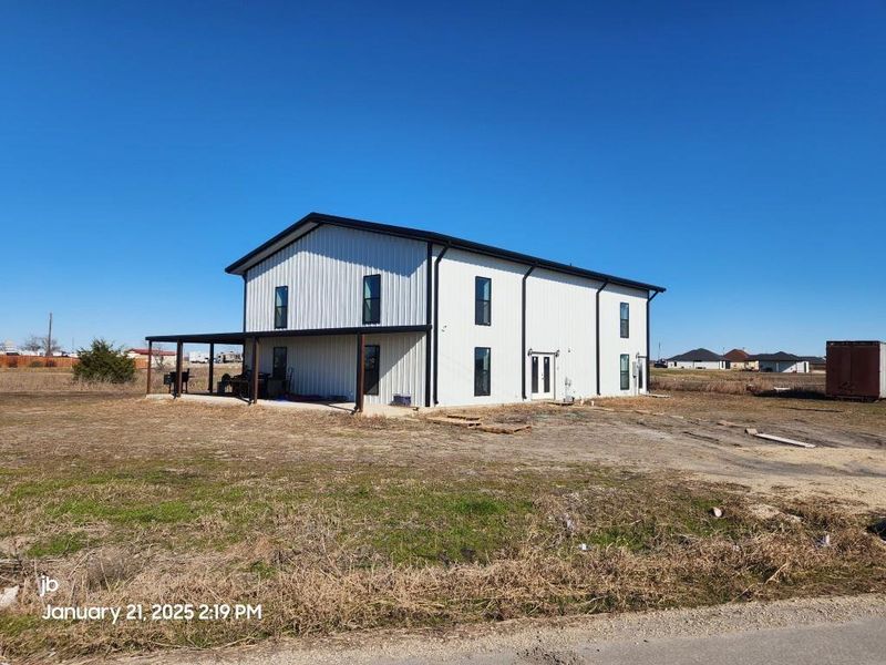 view of home with covered walkway around side to front of the home