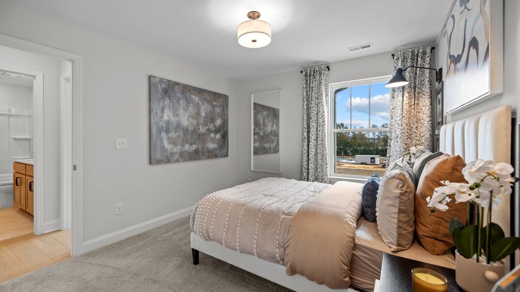 Bedroom with plush carpeting and large window, in the new Adaline Design by DRB Homes Charlotte, NC