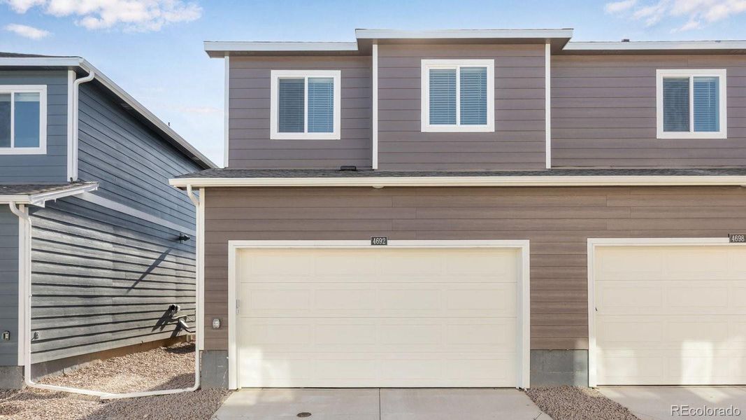 Front exterior of a new home in Revere at Johnstown, Johnstown, CO, highlighting curb appeal (Image 23). Front exterior of a new home in Revere at Johnstown, Johnstown, CO, highlighting curb appeal (Image 23).