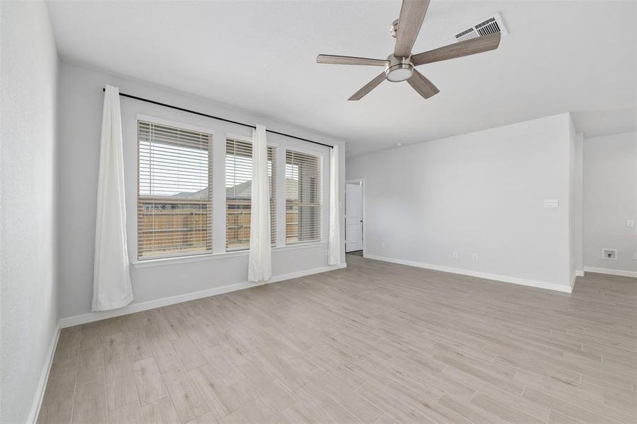 Unfurnished room with ceiling fan and light wood-type flooring