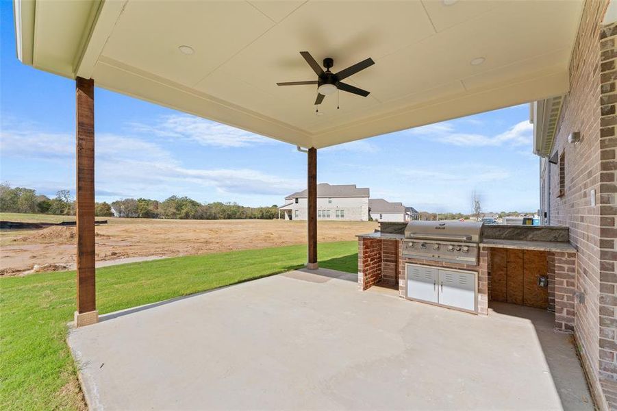 View of patio featuring an outdoor kitchen and ceiling fan