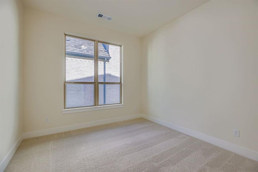Spare room featuring light colored carpet and baseboards Spare room featuring light colored carpet and baseboards