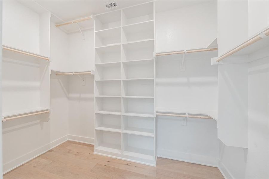 Walk in closet featuring light wood-style flooring