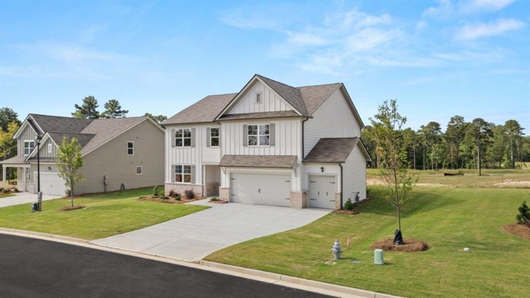 Front exterior of a new home in Fairway 17 at Mirror Lake, Villa Rica, GA, highlighting curb appeal (Image 1).