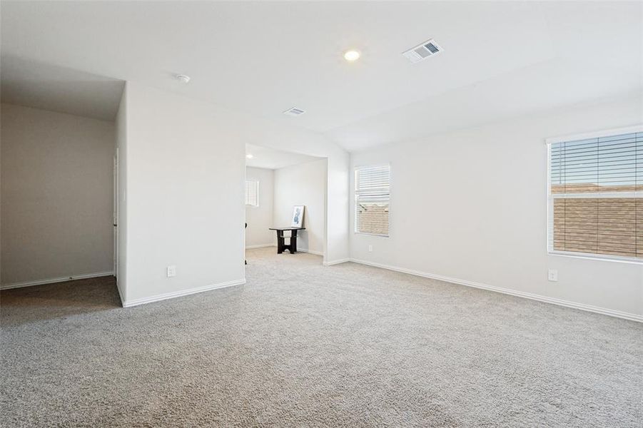 Spacious room featuring light gray carpet, white painted walls, and white trim Spacious room featuring light gray carpet, white painted walls, and white trim