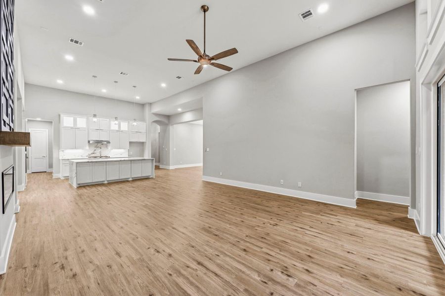 Warm flooring adds richness and character to the expansive living area.