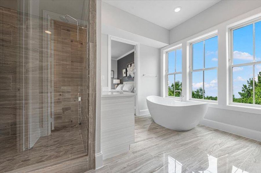 Full bathroom with a stall shower, vanity, and a freestanding bath